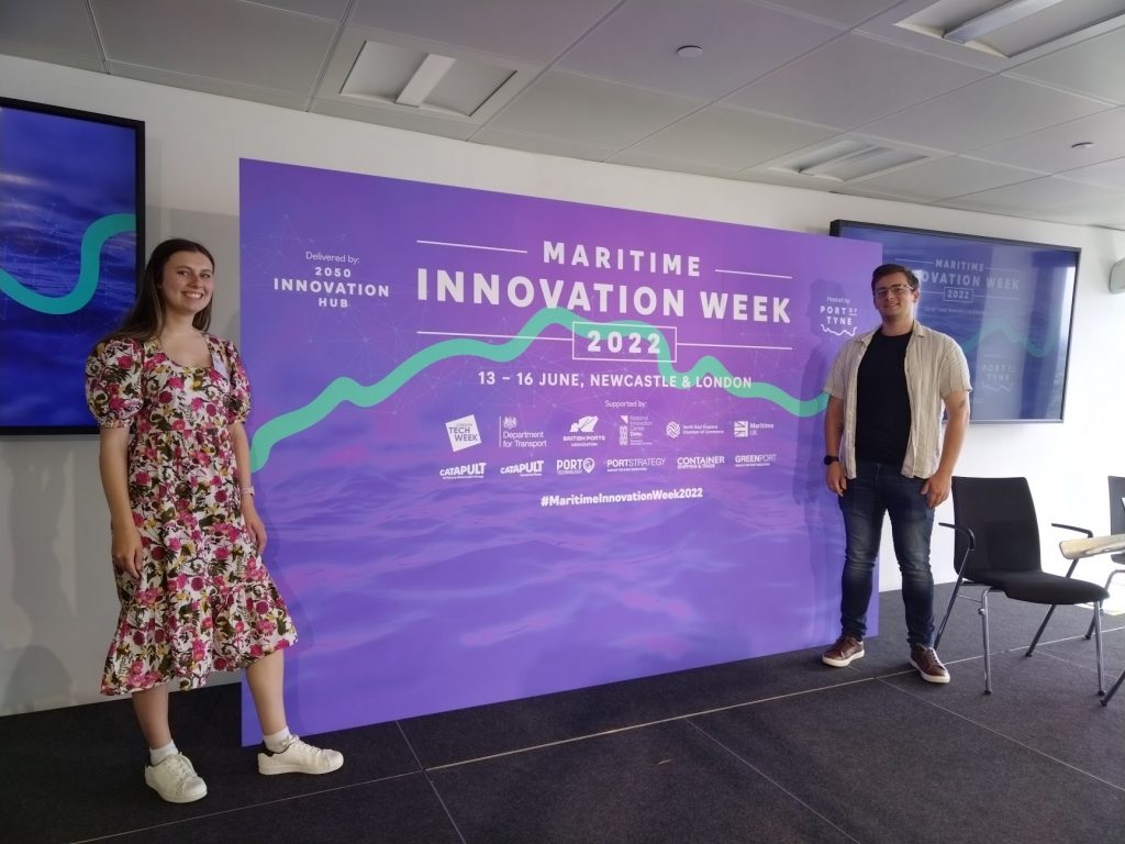 Hannah and Owain infront of a Port of Tyne Maritime Innovation Week banner
